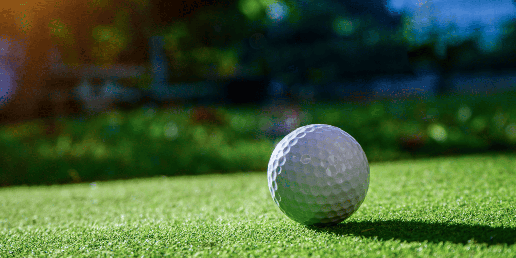 A golf ball on a green grass background