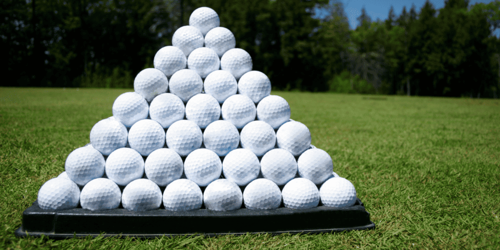 A selection of golf balls on a green grass background