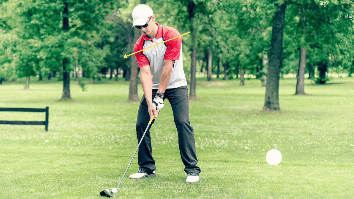 A golfer demonstrating a shoulder tilt as they get ready to tee off
